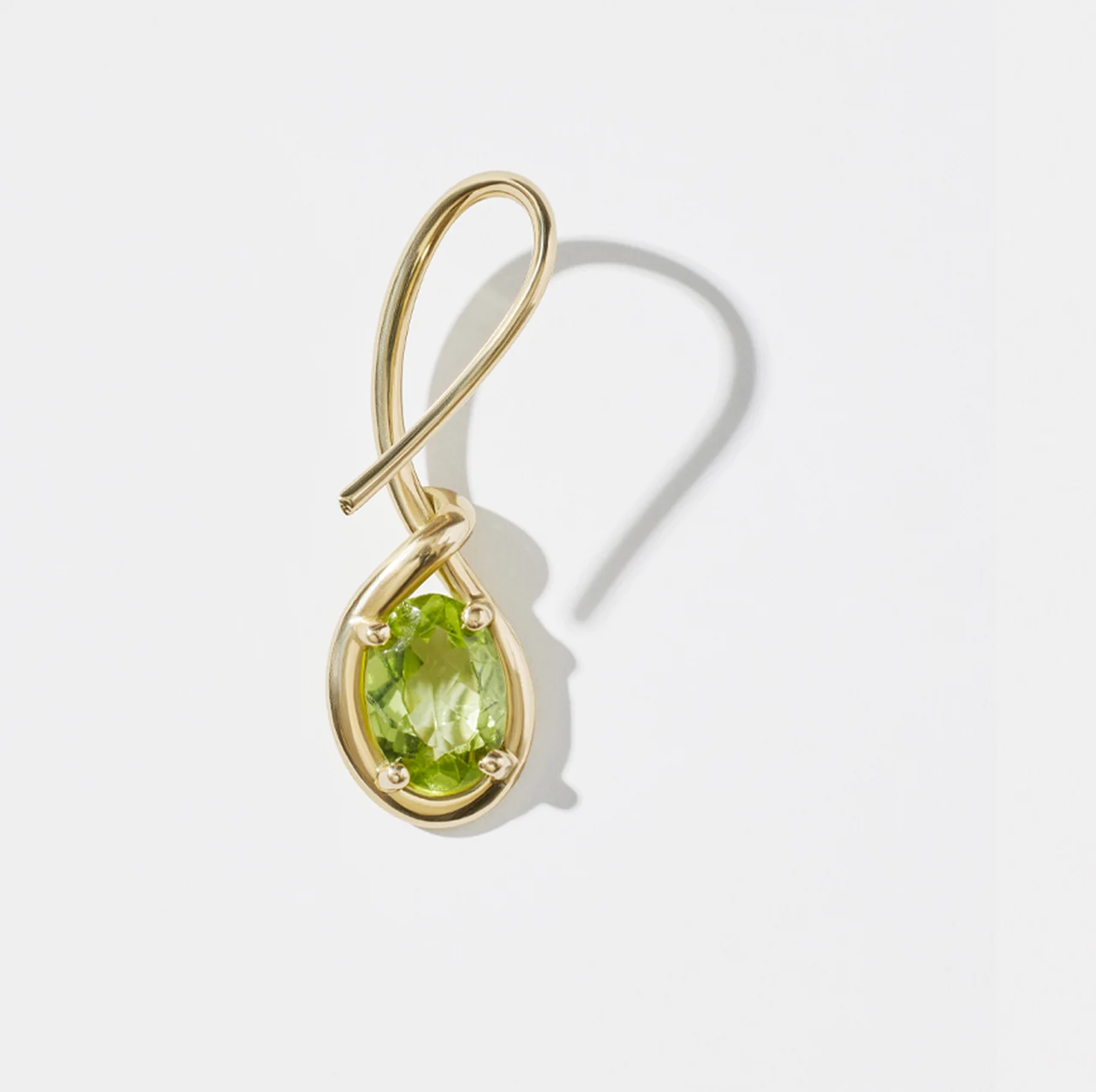 Gold pendant with a green gemstone