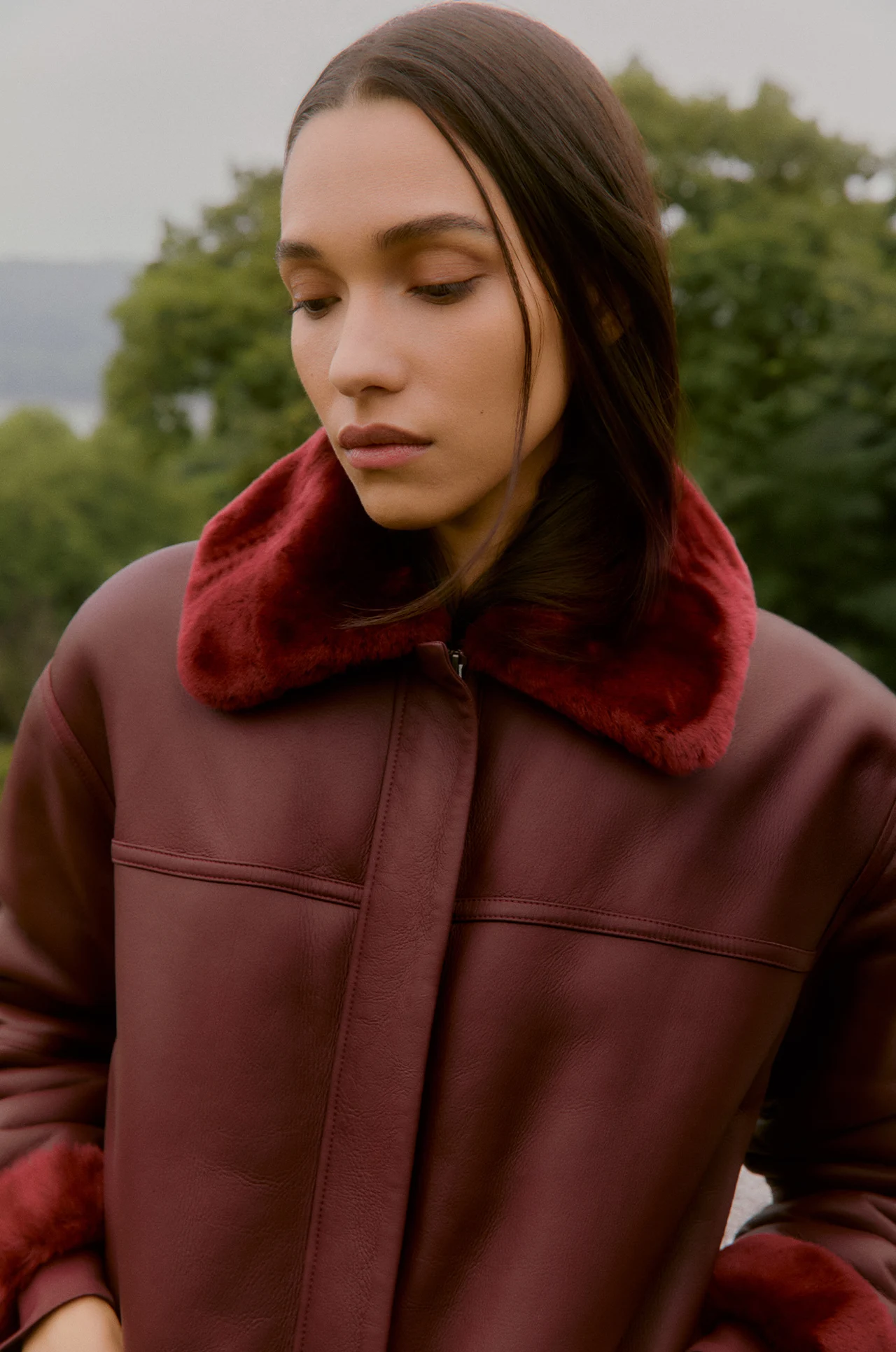 Model wearing a burgundy coat