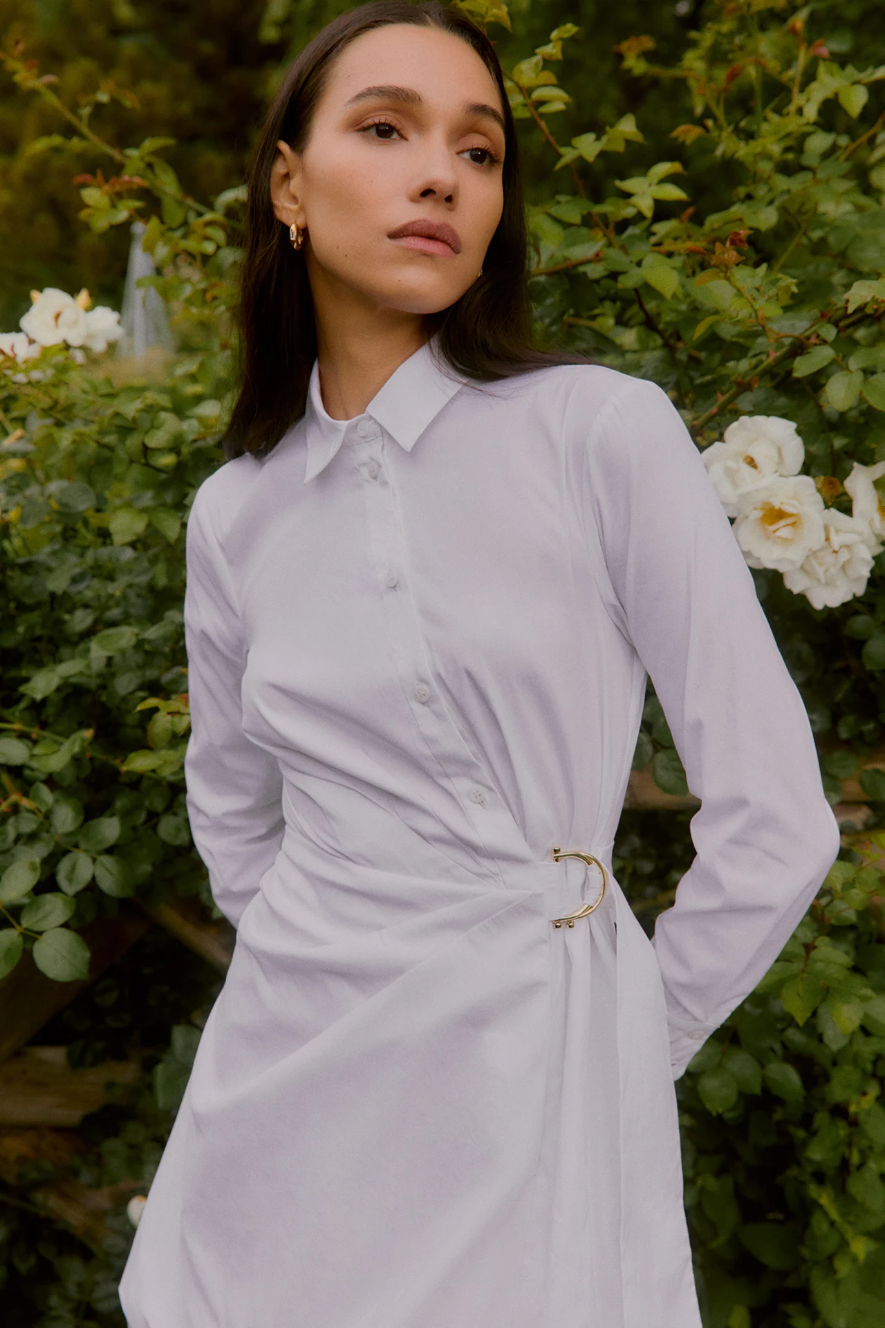 Model wearing a lilac shirt dress in a garden